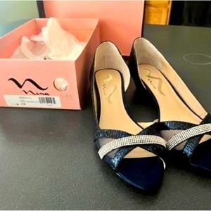 Navy blue and silver accented open toed Nina shoes.